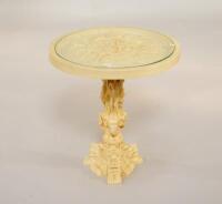 An Indian style glass top occasional table