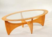 A mid 20thC G Plan oval glass top coffee table