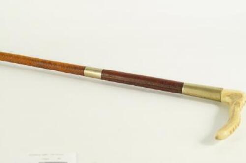 A white metal collared bone handled riding crop