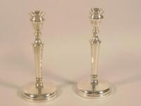 A pair of late 19thC silver candlesticks