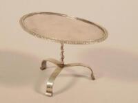 A Continental white metal miniature tilt top table