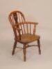 A 19thC child's yew and elm Windsor armchair