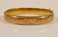 A 9ct gold hinged bangle