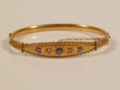 An Edwardian stone set hinged bangle