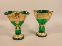 A pair of mid 20thC green Venetian style glass vases