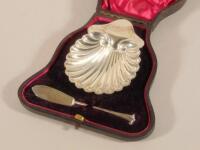 A late Victorian silver shell shaped butter dish and knife