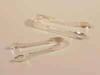 Two sets of silver sugar tongs