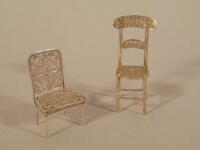 Two white metal and filigree miniature chairs