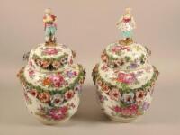 A pair of Dresden flower encrusted porcelain vases and covers