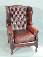 A red leather wingback armchair