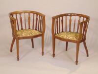 A pair of Edwardian mahogany and boxwood strung tub shaped chairs
