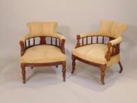 A pair of Edwardian walnut tub shaped chairs