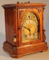 An Edwardian oak cased table clock