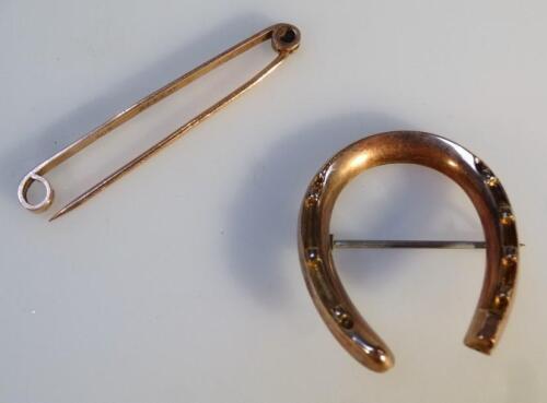 A tie pin and brooch