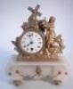 A 19thC gilt metal and marbled mantel clock