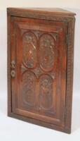 An 18thC oak hanging corner cupboard