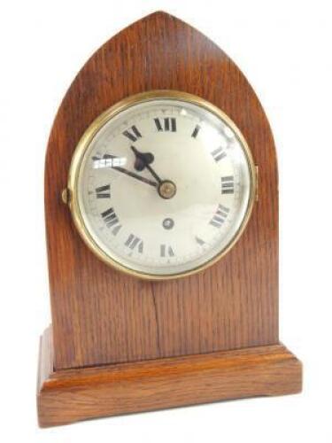 A mid 20thC oak lancet mantel clock