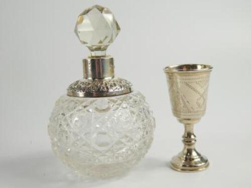 An Edwardian spherical cut glass scent bottle