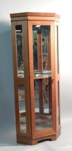 A teak corner cabinet