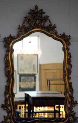 A pair of gilt composition wall mirrors