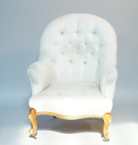 A Victorian button back armchair