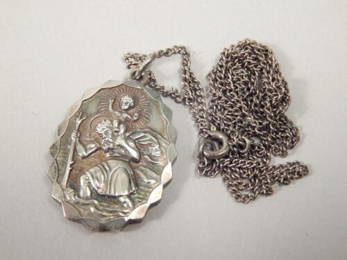 A silver pendant and associated chain