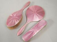 An Art Deco silver and pink guilloche enamel part dressing table set