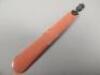 An early 20thC red stained ivory and white metal paper knife