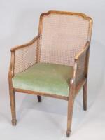 An Edwardian stained beech bergere type chair