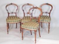 A set of four Victorian walnut balloon back dining chairs