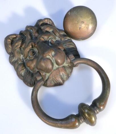 A cast metal lion mask door knocker