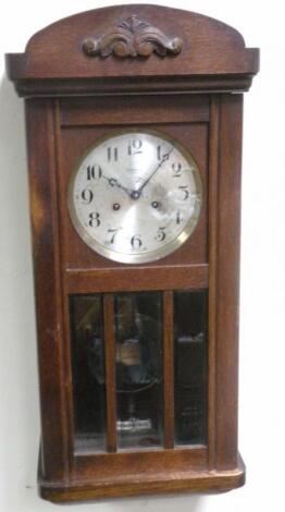 An oak case wall clock