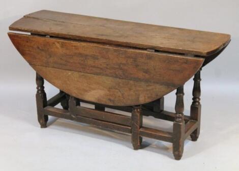 An oak plank top drop leaf table