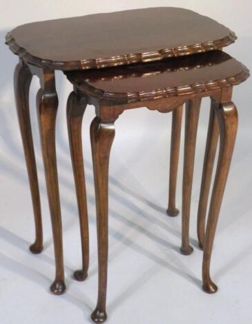 A nest of two mahogany finish tables