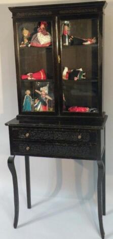 An ebonised bookcase