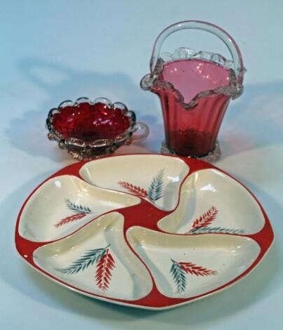 A cranberry glass basket