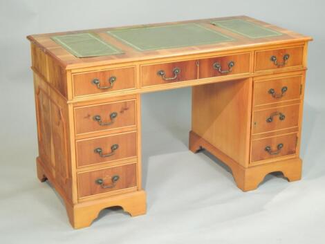 A yew veneered pedestal desk