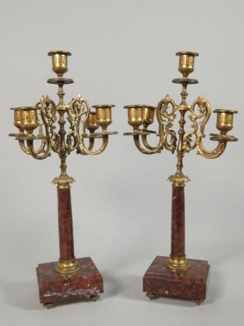 A pair of late 19thC French gilt metal and rouge marble five branch candlebra