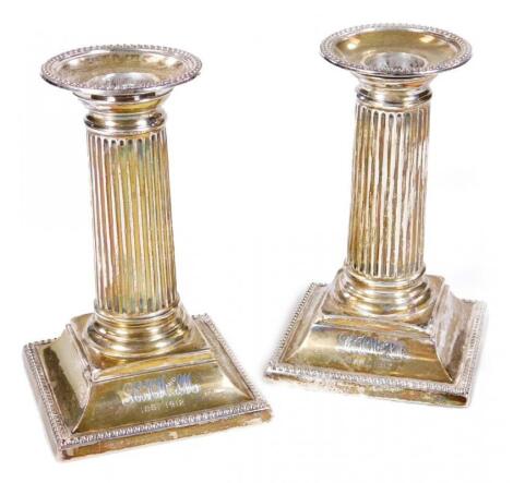 A pair of Edwardian silver candlesticks