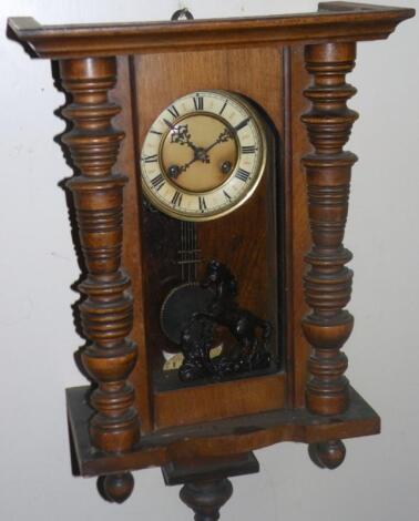 An early 20thC walnut and beech cased Vienna style wall clock