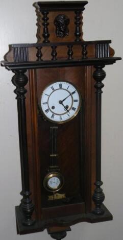 An early 20thC walnut and mahogany stained Vienna wall clock