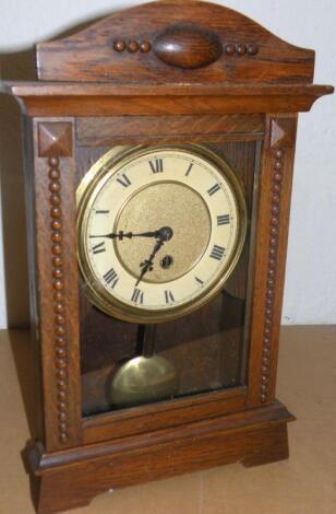 An early 20thC oak cased mantel clock