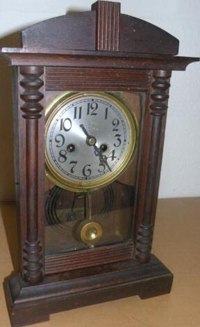 An early 20thC pine and oak cased mantel clock