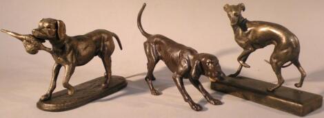 *Three small cast dog figures