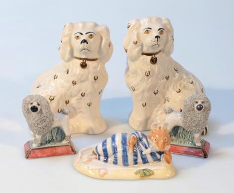 A pair of Staffordshire figures of poodles