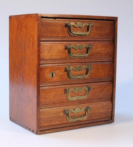 A bank of five Edwardian oak drawers