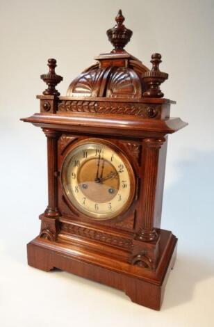 A late 19thC/early 20thC walnut cased mantel clock