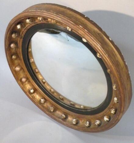 A George IV style gilt wood and plaster convex port hole mirror