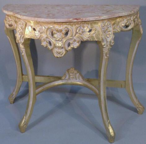 A 20thC Italian marbled and gilt wood console table