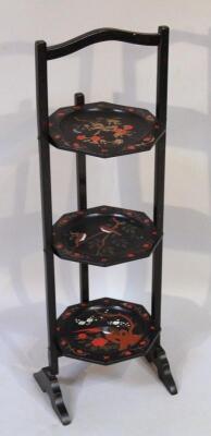 A black lacquer three sectional cake stand